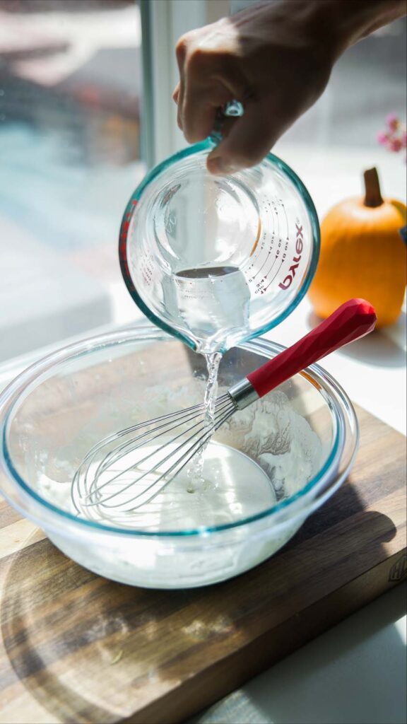 adding water to tempura batter mix